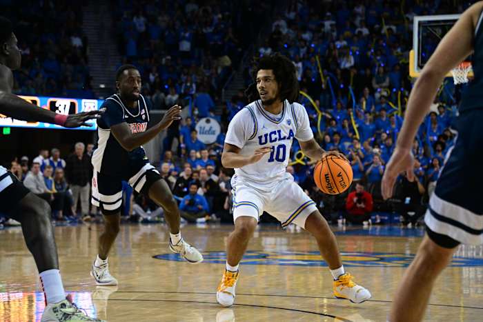 UCLA Bruins guard Tyger Campbell dribbles the ball against the Arizona Wildcats defense.